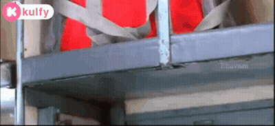 A Red Bag Is Hanging From A Metal Railing With A Kulfy Logo On The Bottom Right GIF