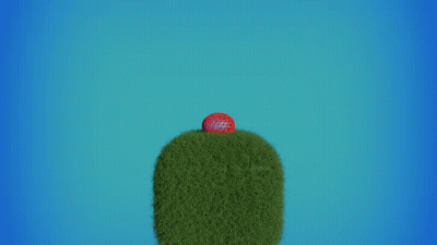 A Red Ball Is Flying Through The Air Over A Green Hill GIF