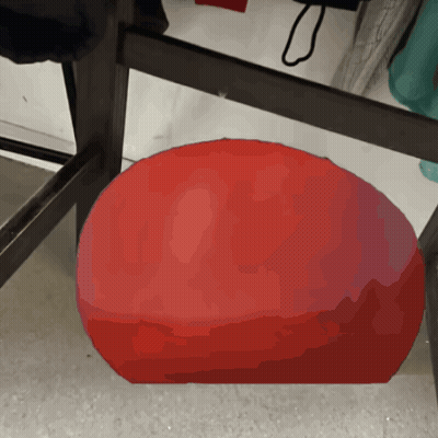 A Red Ball Is Sitting On A Table In A Store GIF