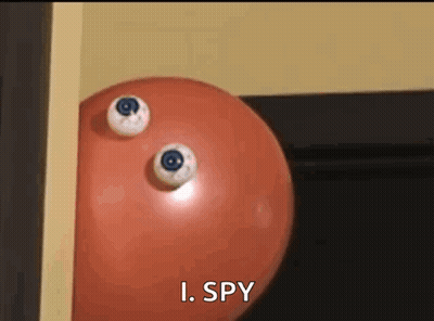 A Red Ball With Two Eyes On It And The Words I Spy Below It GIF