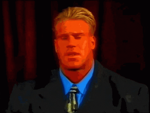 A Red Bodybuilder Is Flexing His Muscles In Front Of A Yellow Background GIF
