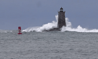 A Red Buoy With The Letter N On It Is In The Middle Of The Ocean Near A Lighthouse GIF