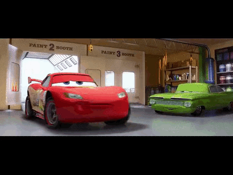 A Red Car And A Green Car In A Garage With Paint Booth Written On The Wall GIF