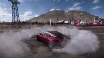 A Red Car Is Drifting On A Road With Smoke Coming Out Of The Tires GIF