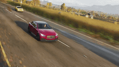 A Red Car Is Driving Down A Country Road GIF