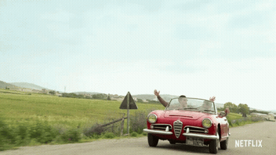 A Red Car Is Driving Down A Dirt Road With Netflix Written On The Bottom GIF