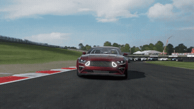 A Red Car Is Driving Down A Race Track In A Video Game GIF