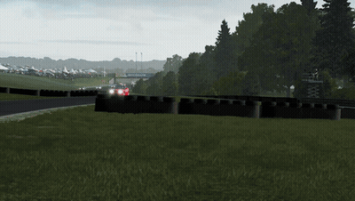 A Red Car Is Driving Down A Race Track With A Sign That Says Michelin On The Side GIF