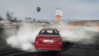 A Red Car Is Driving Down A Road With Smoke Coming Out Of Its Tires GIF