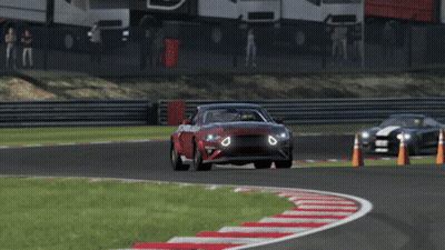 A Red Car Is Driving On A Race Track GIF