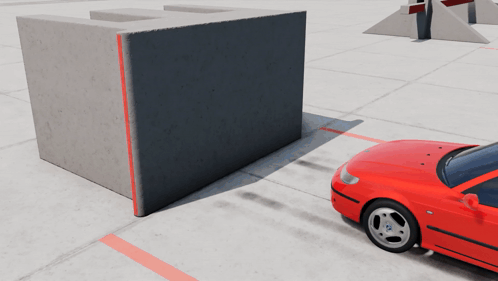 A Red Car Is Parked In Front Of A Concrete Wall GIF