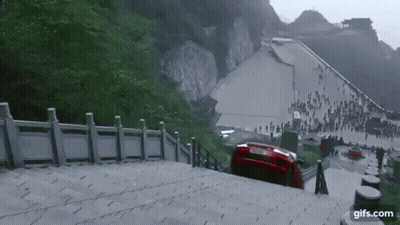 A Red Car Is Stuck On A Set Of Stairs With The Website Gifs.com In The Lower Right Corner GIF
