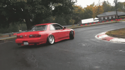 A Red Car On A Track With A License Plate That Says ' Nc ' GIF