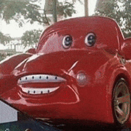 A Red Car With Big Eyes And A Smile On It GIF