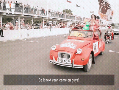 A Red Car With The License Plate E961 Acp Is Driving Down The Road GIF