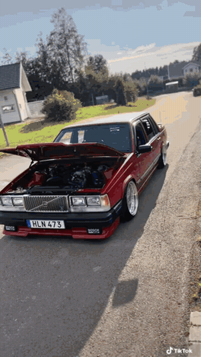 A Red Car With The License Plate Hln 473 Is Parked On The Street GIF