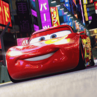 A Red Cartoon Car Is Driving Down A Street With A Sign That Says ' R ' On It GIF