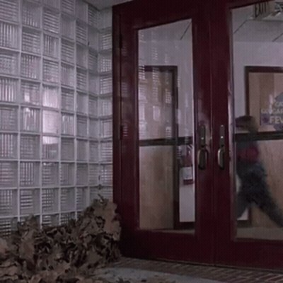 A Red Door With A Sign That Says Exit GIF