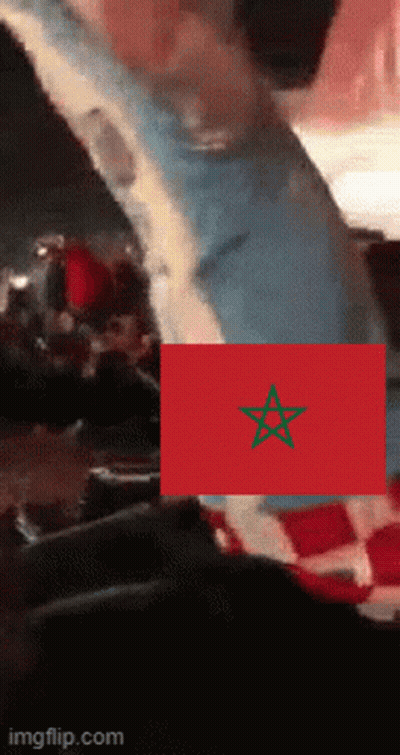 A Red Flag With A Green Star On It Is Being Displayed On A Screen GIF