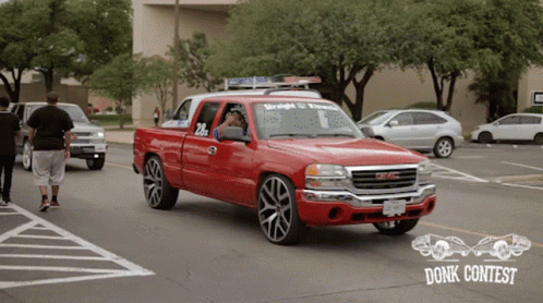 A Red Gmc Truck With The Number 20 On The Side GIF