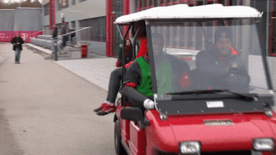 A Red Golf Cart With The Word T Mobile On The Side GIF