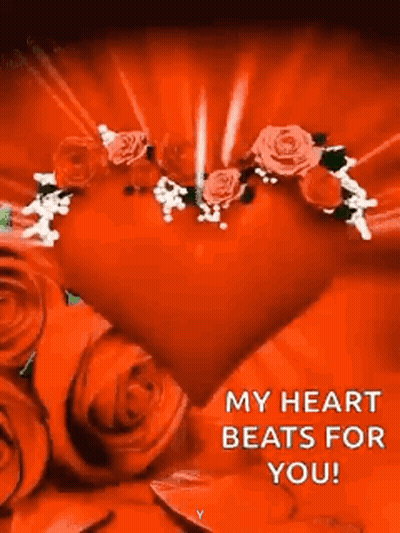 A Red Heart Surrounded By Red Roses With A Message That Says `` My Heart Beats For You '' . GIF