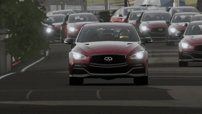 A Red Infiniti Car Driving Down A Road GIF