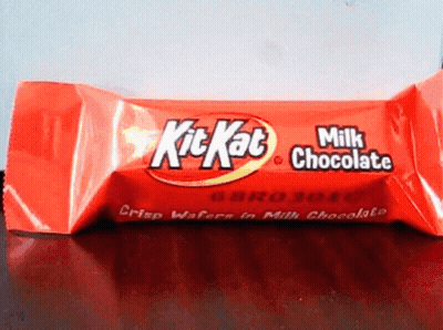 A Red Kitkat Milk Chocolate Bar Sitting On A Table GIF