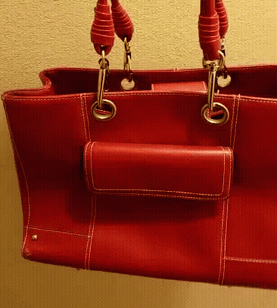 A Red Leather Purse With A Small Pocket On The Side Of It GIF
