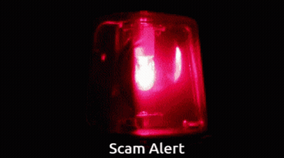 A Red Light With The Words Scam Alert Written Below It GIF