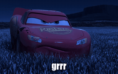 A Red Lightning Mcqueen Car Is Sitting In A Field Of Tall Grass GIF