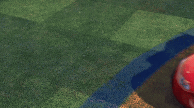 A Red Lightning Mcqueen From Cars Is Driving On A Grassy Field GIF
