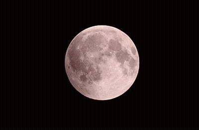 A Red Moon In The Night Sky With A White Crescent GIF