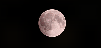 A Red Moon Is Visible In The Dark Sky GIF
