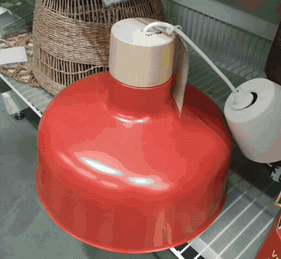 A Red Pendant Light With A Wooden Top GIF