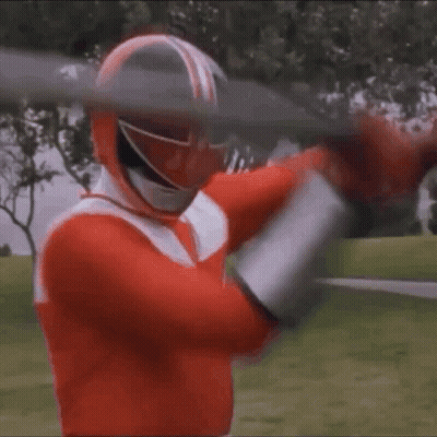 A Red Power Ranger Is Holding A Large Sword In His Hands . GIF