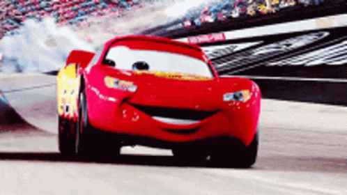 A Red Race Car From The Movie Cars Is Smiling GIF