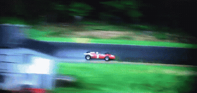 A Red Race Car With The Number 1 On The Side Is Driving Down A Track GIF