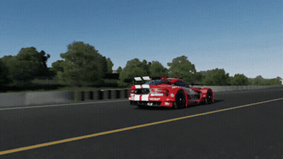 A Red Race Car With The Word Castrol On The Side Is Driving Down A Road GIF