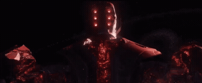 A Red Robot With A Glowing Head Is Standing In The Dark GIF