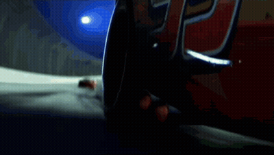 A Red Rusteze Race Car Is Driving Down A Track GIF