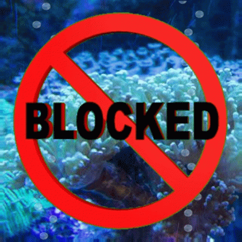 A Red Sign That Says Blocked In Black Letters GIF