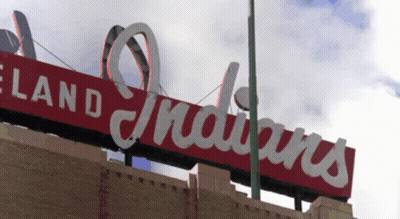 A Red Sign That Says Cleveland Indians On Top Of A Building GIF