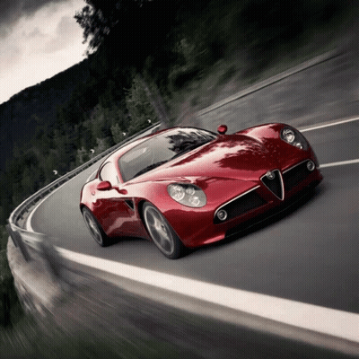 A Red Sports Car Is Driving Down A Road GIF