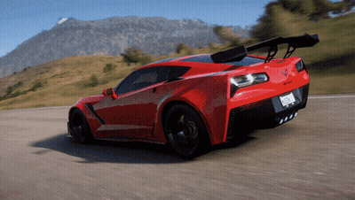 A Red Sports Car Is Driving Down A Road With Mountains In The Background And A License Plate That Says California GIF