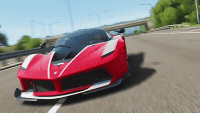 A Red Sports Car Is Driving Down The Road GIF