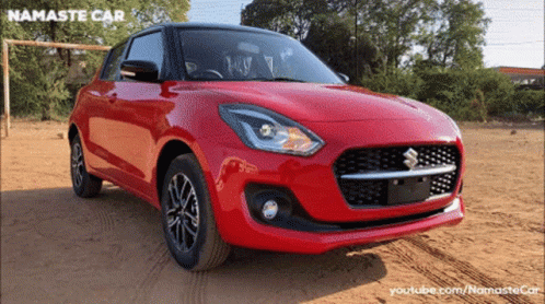 A Red Suzuki Car Is Parked In A Dirt Field With Namaste Car Written On The Bottom GIF