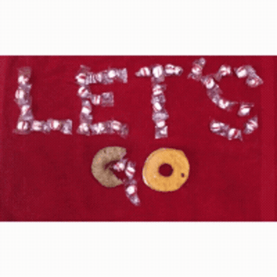 A Red Towel With The Words Let 'S Go Written In Candy GIF
