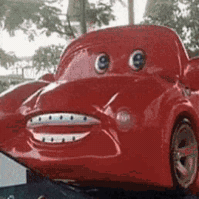 A Red Toy Car With Big Eyes And A Smile On Its Face GIF