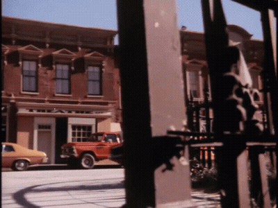 A Red Truck Is Parked In Front Of A Building That Says ' A & A ' On It GIF